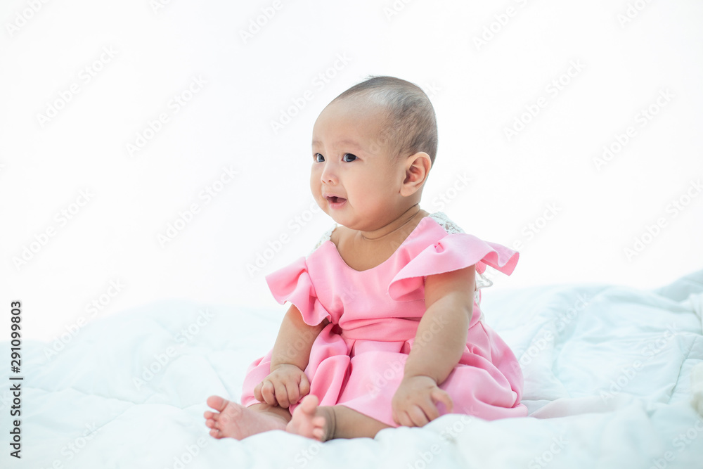Sad baby on a white bed Sad baby on a white bed