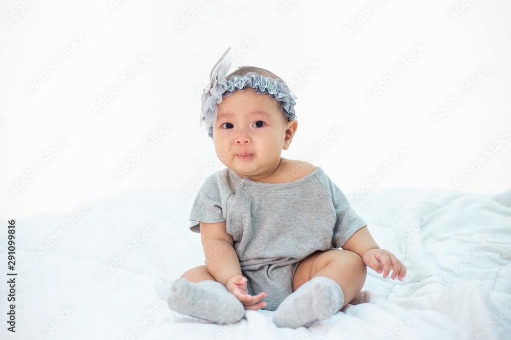 Babies are sad on a white bed. Babies are sad on a white bed.