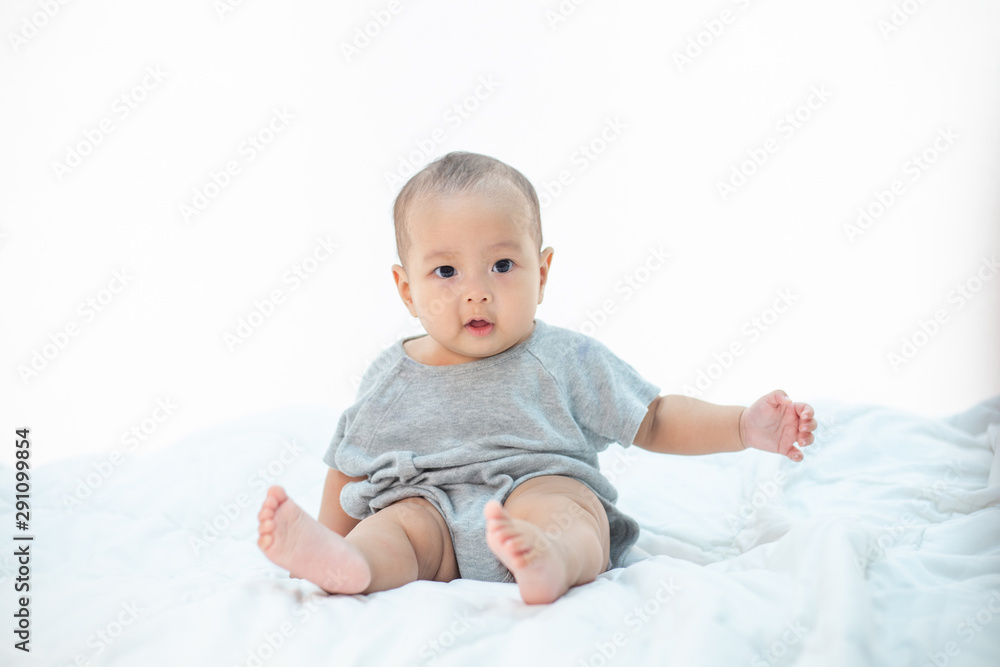 The little boy sitting on the bed The little boy sitting on the bed