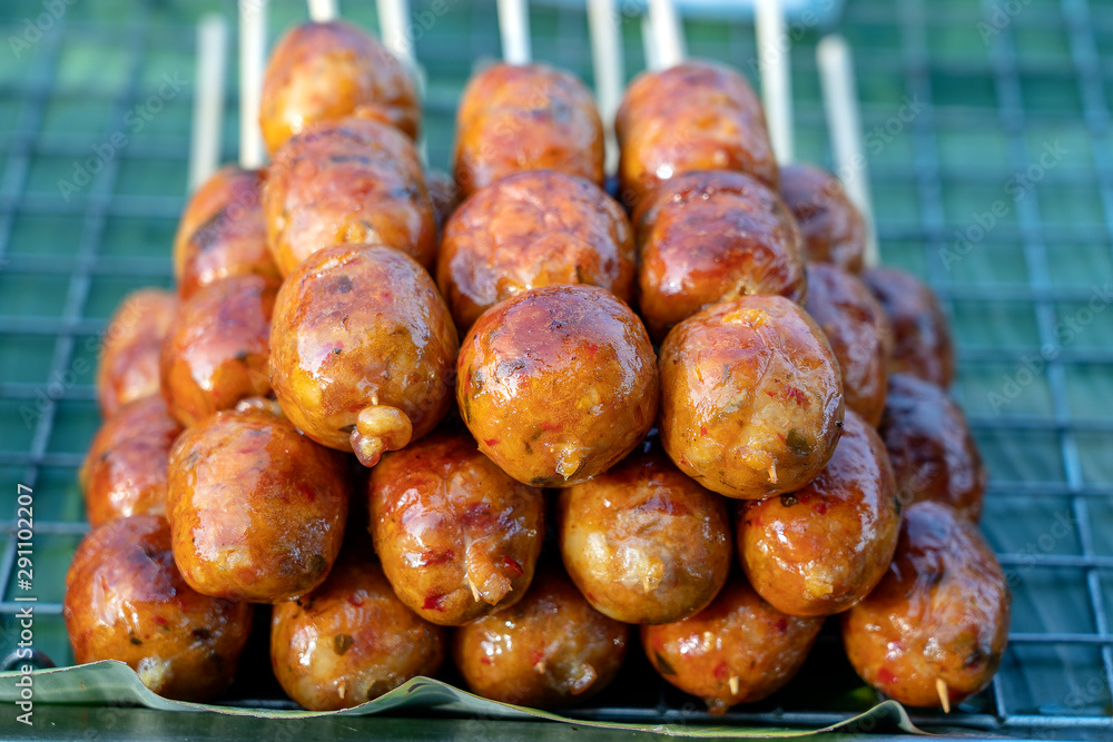 Grilled Thai sausage at street food market in Thailand, closeup. Traditional Thai sausage with pork and rice, delicious street food Grilled Thai sausage at street food market in Thailand, closeup. Traditional Thai sausage with pork and rice, delicious street food