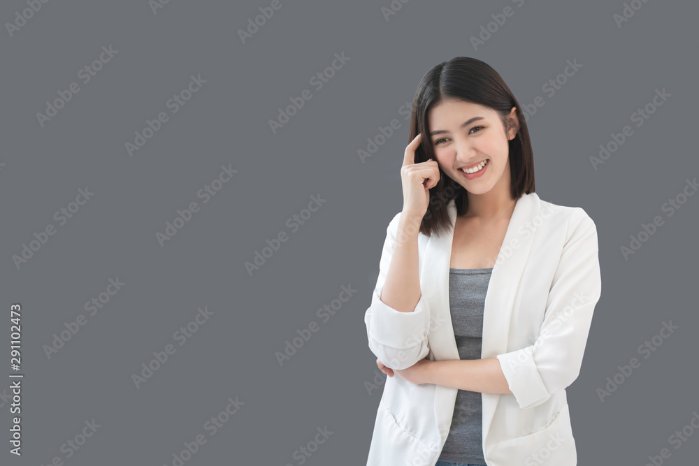 Portrait of smart young Asian businesswoman thinking of many ideas about work or project, a positive attitude, working inspiration, explore new ideas, clipping path embed,isolated on grey background. Portrait of smart young Asian businesswoman thinking of many ideas about work or project, a positive attitude, working inspiration, explore new ideas, clipping path embed,isolated on grey background.