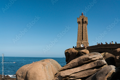 horizontal view of many tourists visiting thePhare de Mean Ruz Lighthouse on the granite coast in Brittany © makasana photo