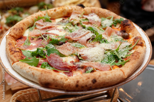 Pizza with prosciutto ham and grated parmesan