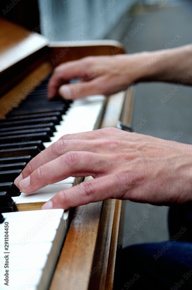 Hands playing the piano close up