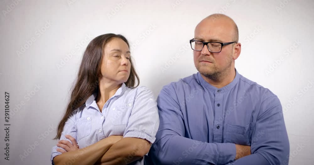 spouses in quarrel are crossed hands on chest and turning away from each other spouses in quarrel are crossed hands on chest and turning away from each other