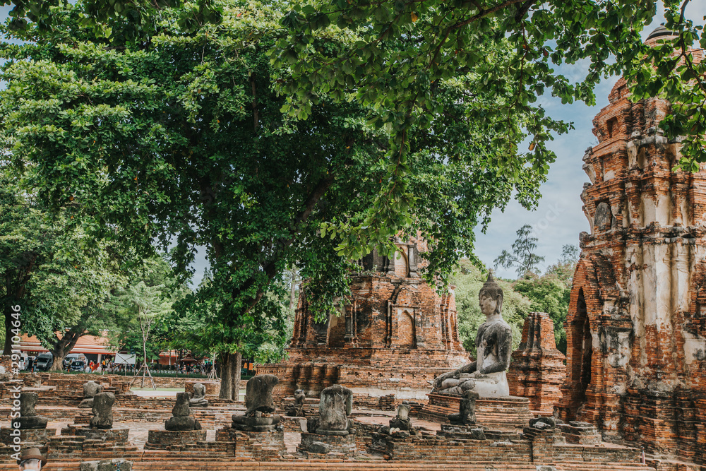 Amazing details of the Wat Maha That temple with the ruins of the Buddha statues.