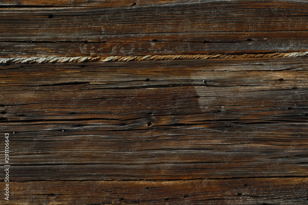 old brown plank wall with rope of old wooden house old brown plank wall with rope of old wooden house