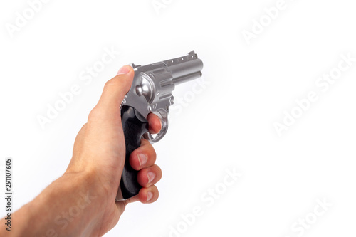Hand holding a silver gun pulling the trigger, revolver in hand pointed away. Wild west handgun silver bullet pistol, dangerous shooter concept. Man pulling the trigger closeup isolated on white