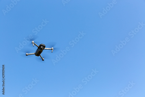 A drone flying against the blue sky
