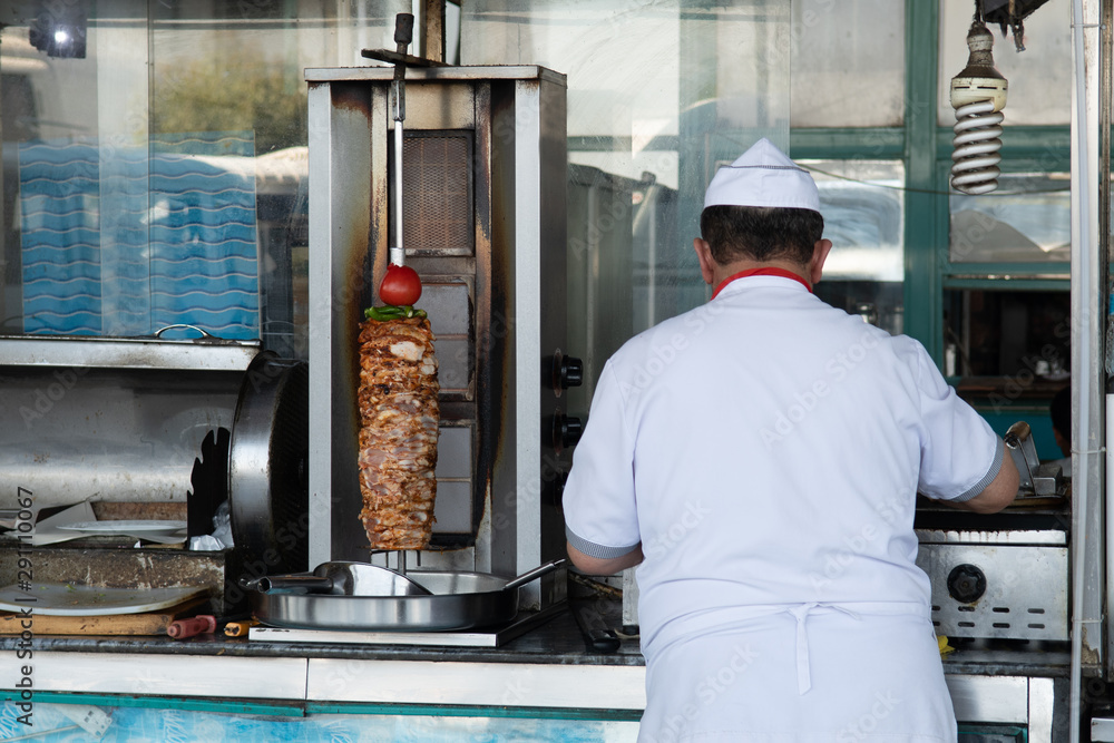 Unidentifiable Turkish Doner Kebab vendor. Fast food eatery