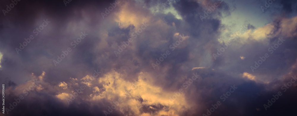 Vintage background of dramatically illuminated stormy clouds