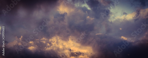 Vintage background of dramatically illuminated stormy clouds