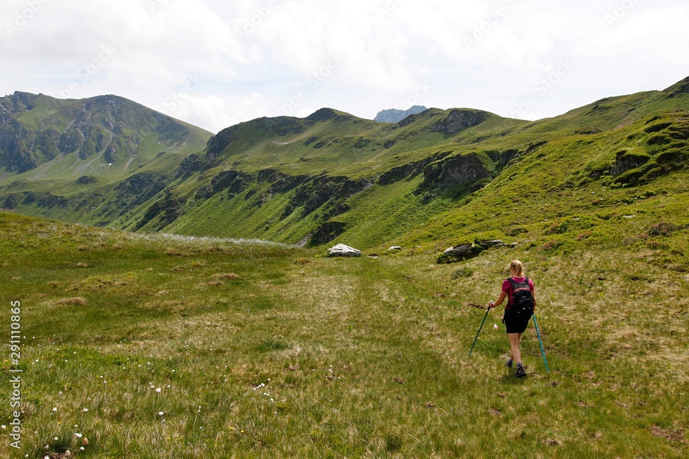 Person hiking in the alps on a summer day near Saalbach in Austria