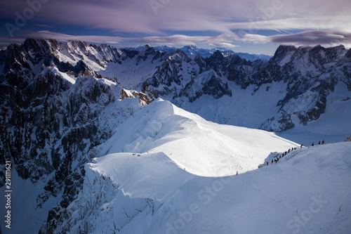 View from Aiguille du Midi, France. Skiers going down on Mer de Glace . © belyaaa