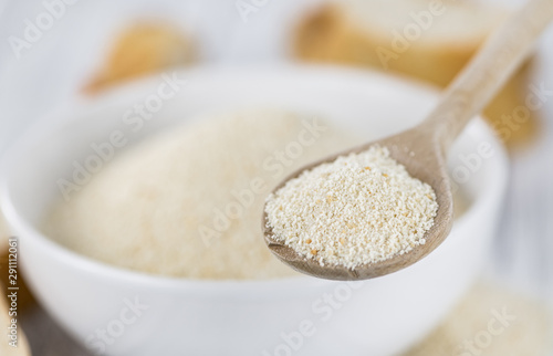 Breadcrumbs on a wooden spoon (close-up shot; selective focus)