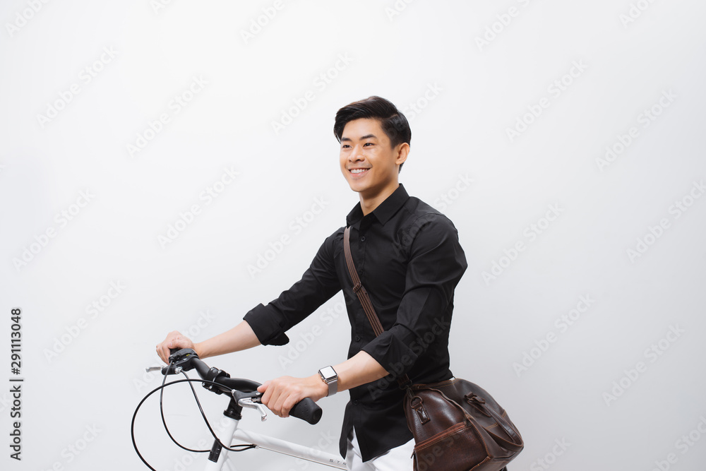 Stylish handsome young man with bicycle looking away isolated on white Stylish handsome young man with bicycle looking away isolated on white