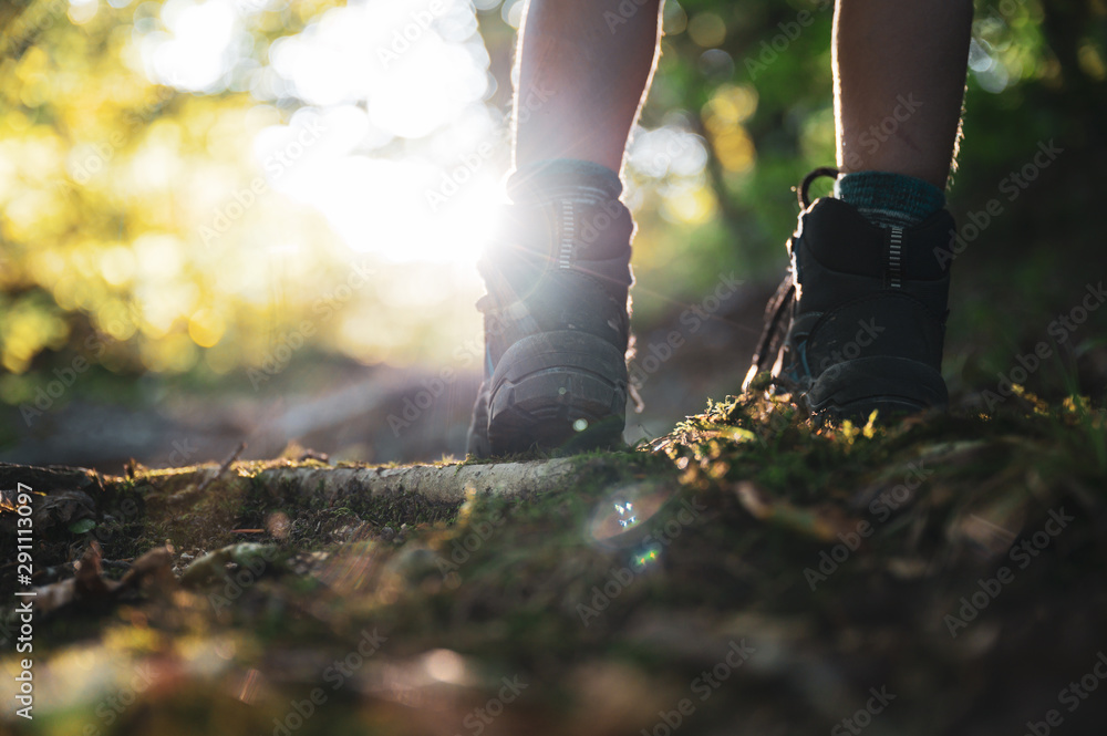 Low angle view of childs legs wearing mountain shoes walking uphill Low angle view of childs legs wearing mountain shoes walking uphill