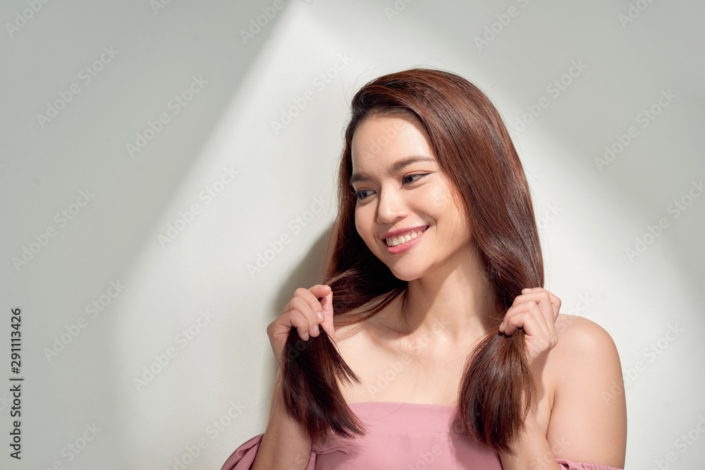 young girl posing near white wall smiling. Summer woman. Warm spring young girl posing near white wall smiling. Summer woman. Warm spring