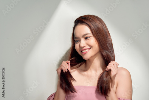 young girl posing near white wall smiling. Summer woman. Warm spring