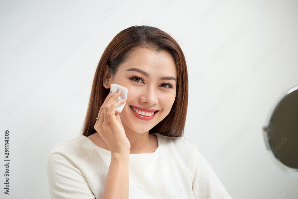 beautiful girl cleans the face of makeup with a cotton pad beautiful girl cleans the face of makeup with a cotton pad