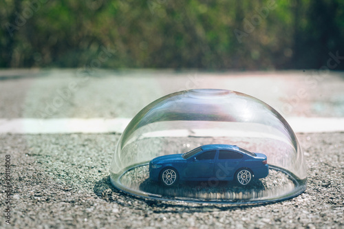 Blue car protected under a glass dome