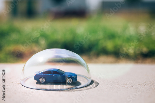 Blue car protected under a glass dome