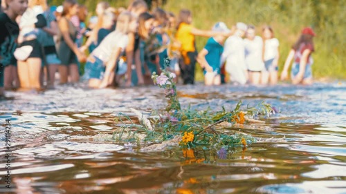 Celebration of Ivan Kupala. Girls and women lay wreaths on the water. Folk tradition photo