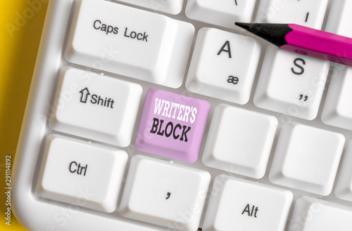 Writing note showing Writer S Block. Business concept for Condition of being unable to think of what to write White pc keyboard with note paper above the white background photo