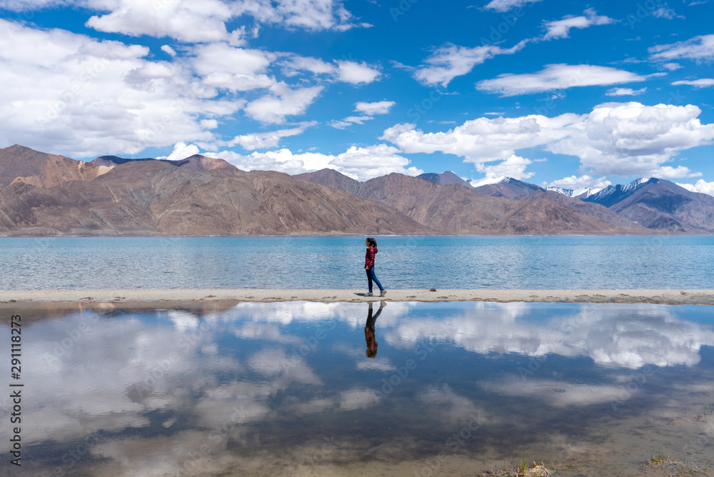 Landscape view of tourist woman enjoy with beautiful of Pangong lake in Leh Ladakh, India