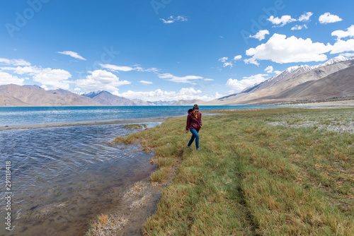 Landscape view of tourist woman enjoy with beautiful of Pangong lake in Leh Ladakh, India © mnonchan