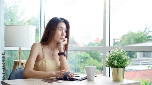 Young beautiful Asian woman enjoying a relaxing moment working and using mobile phone as mobile smart payment to pay for a coffee in the coffeeshop on a bright sunny day Free Download Young beautiful Asian woman enjoying a relaxing moment working and using mobile phone as mobile smart payment to pay for a coffee in the coffeeshop on a bright sunny day - GFXLoad