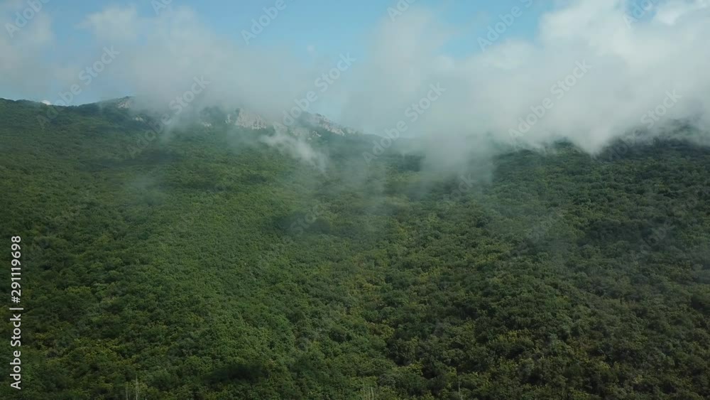Crimea with Beautiful View of Mountains and highway road between the mountains. Aerial View Of Fast Rolling Clouds Drifting Over mountains and hills. Crimea with Beautiful View of Mountains and highway road between the mountains. Aerial View Of Fast Rolling Clouds Drifting Over mountains and hills.