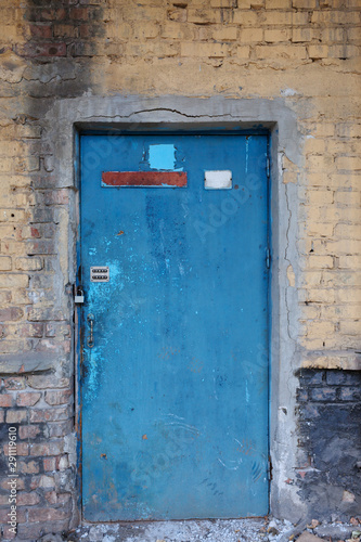  Old vintage wall with worn metal door © supersomik