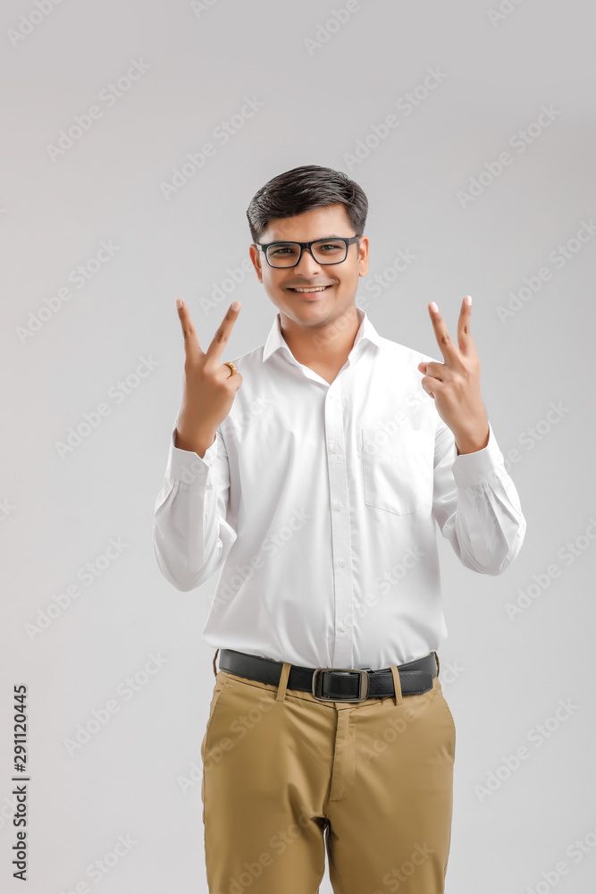 Young Indian man showing victory sign Young Indian man showing victory sign