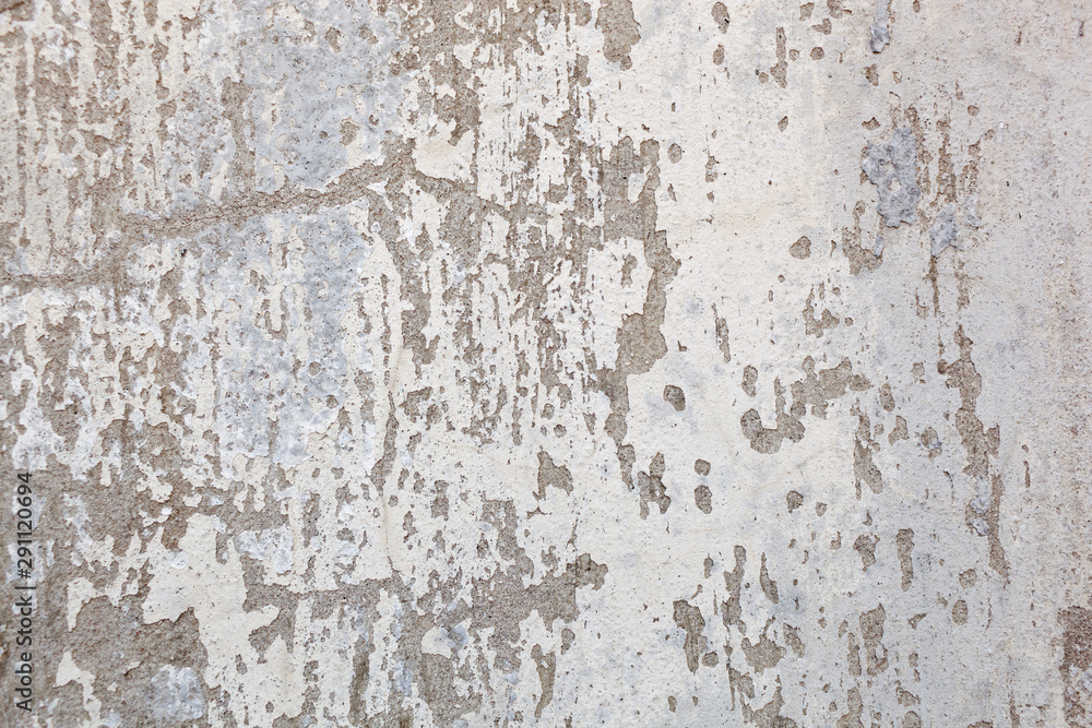 Texture of a concrete wall with cracks and scratches which can be used as a background Texture of a concrete wall with cracks and scratches which can be used as a background