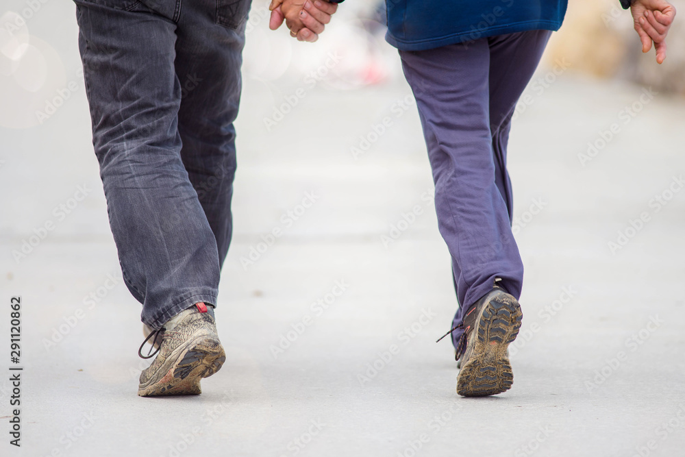senior or adult couple strolling hand in hand