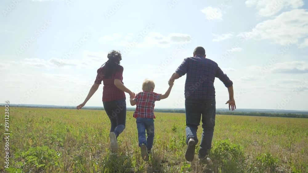 happy family runs nature teamwork friendship care concept slow motion video. father mom and son running in nature sunset sunlight hold hand. happy family parents man and girl hold little boy a run happy family runs nature teamwork friendship care concept slow motion video. father mom and son running in nature sunset sunlight hold hand. happy family parents man and girl hold little boy a run