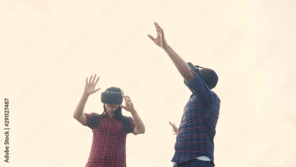 Augmented teamwork future reality device creating virtual lifestyle space concept slow motion video. man and woman in virtual digital glasses the virtual reality. couple using VR-headset