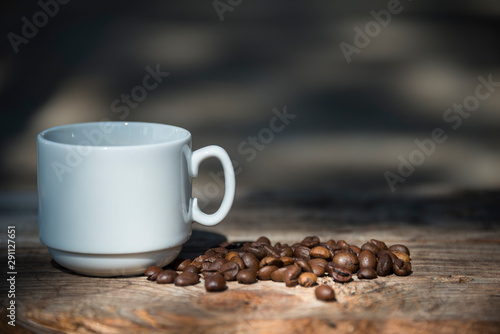 coffee Cup and coffee beans on wooden background