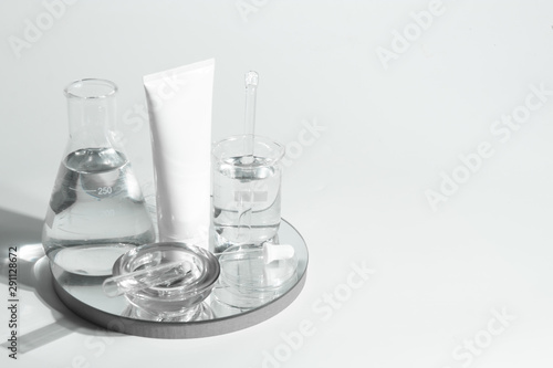 beauty spa medical skincare and cosmetic lotion bottle cream packaging product on white decor background and laboratory test glass tube in doctor healthy science concept © issaronow