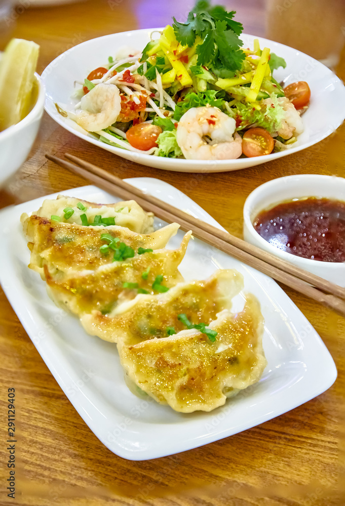 Have gyoza or fried dim sums are on a plate in the restaurant