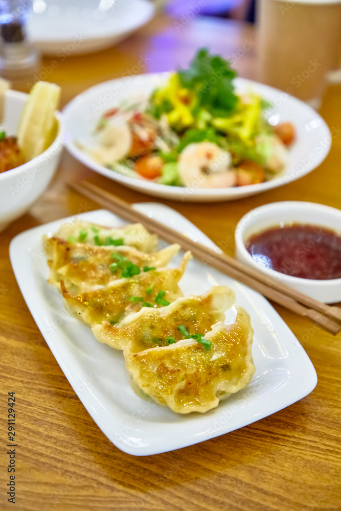 Have gyoza or fried dim sums are on a plate in the restaurant