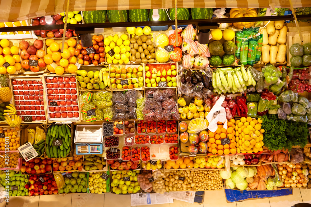 Counter with fruits and vegetables in the market.
