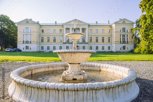 City Mezotne  Latvia Republic. Park with old castle. Fountain and green zone. Sep 9. 2019 Travel photo.