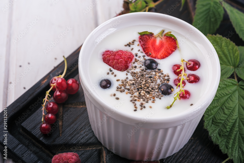 Healthy greek yogurt in a ceramic bowl with fresh berries and chia seeds Healthy greek yogurt in a ceramic bowl with fresh berries and chia seeds