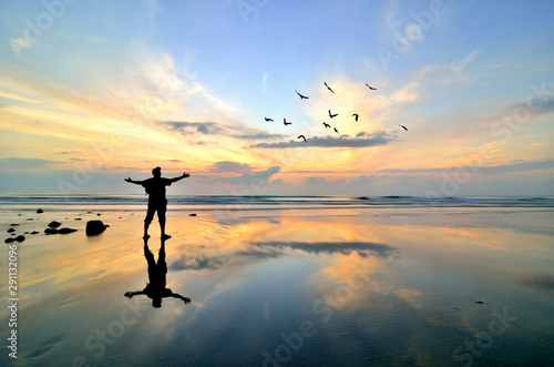 Man standing near the beach looking at sun rising © shahrilkhmd
