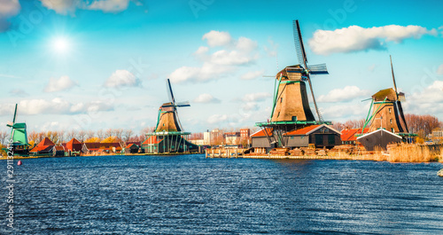 Famous windmills in Kinderdijk museum in Holland. Sunny spring morning in countryside. Colorful outdoor scene in Netherlands, Europe. UNESCO World Heritage Site. Instagram filter toned.