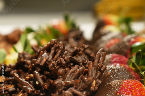 Chocolate crackles with strawberries in the background © PhotosbyJ