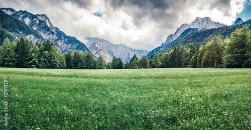 Dramatic summer panorama of Triglav mountain range. Gloomy mporinng view of Julian Alps, Slovenia. Beauty of nature concept background. Instagram filter toned.