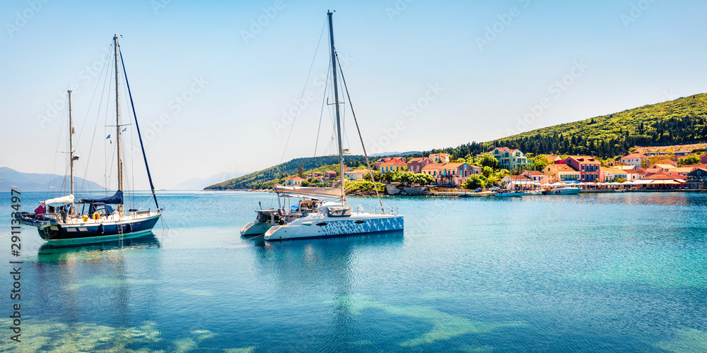 Great panoramic view of Fiskardo port. Splendid spring seascape of Ionian Sea. Colorful morning scene of Kefalonia island, Greece, Europe. Traveling concept background.